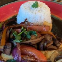 Vegan Lomo Saltado · Marinated Shiitake Mushrooms browned and mix together with sautéed onions, tomatoes and a li...