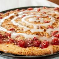 Cherry Dessert Pizza · Cherry pie filling on a pizza with our house-made crumb topping and a drizzle of glaze on top!