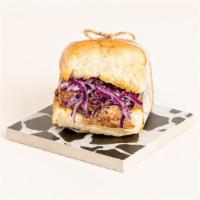 Bbq Brisket Slider · Delicious brisket with bbq sauce, coleslaw, and pickles on a toasted bun.