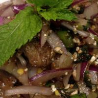 Num Tok · Pan-seared beef, ground roasted rice, red onion, cilantro, mint, green onion, and Thai lime ...