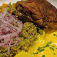 Arroz Con Pollo · Chicken and rice cooked with cilantro sauce, combined with carrots, sweet peas and bell pepp...