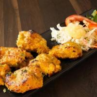 Fish Tikka · Chunks of fresh fish marinated with garlic, lemon juice and spiced to perfection. Served wit...