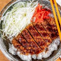 Tonkatsu Rice Bowl · Our version of the classic, deep-fried Japanese pork cutlet, served in a bed of shredded cab...