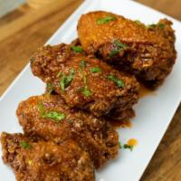 12 Bone-In Wings · Breaded or naked jumbo party chicken seasoned and fried to perfection.