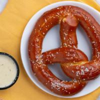 Bavarian Pretzel · Pretzel Served with House-Made Warm Queso and Honey Spiked Mustard.