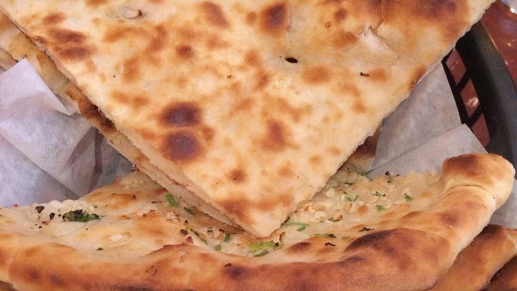 Naan · Traditional/ Punjabi battered white bread baked in clay oven.