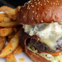 Brown Iron Burger · Michigan Wagyu beef burger, topped with thick cut bacon, cheddar, caramelized onion spread, ...