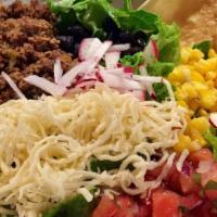 Taco Salad
 · Greens Topped with Jalapeño-Cilantro Vinaigrette, Pico de Gallo, Roasted Corn, Cheese, Radis...