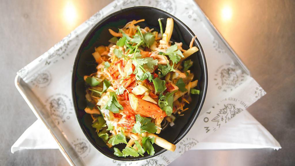 Kimchi Fries · An American favorite United with Asian flavors. Fresh cut fries, Jack and Cheddar cheese, onion, jalapeno, cabbage kimchi, cucumber kimchi, choice aioli, and cilantro.