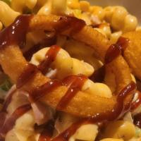 3 Little Pigs Mac · Grandma's mac with fiery BBQ sauce, bacon, pulled pork, ham, & jalapeno topped with onion ri...