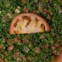 Tabbouli · Parsley, onions, tomatoes, cracked wheat, olive oil, fresh lemon and spices.