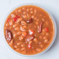 Smoked Baked Beans · Our famous smoked baked beans with smoked beef sausage fresh from the grill daily.