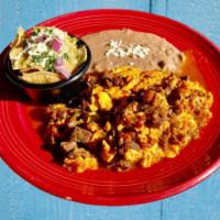 Huevos Aporreados · Scrambled Eggs with Steak & roasted red salsa with a side of Green Chilaquiles and refried b...