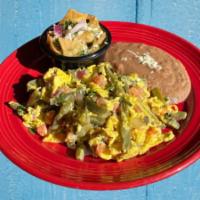 Huevos Con Nopales · Scrambled eggs with cactus with a side of Green Chilaquiles and refried beans. (Vegetarian)