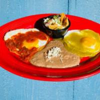 Huevos Divorciados · Sunny side-up eggs topped with roasted red and tomatillo green salsa with a side of green ch...