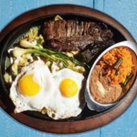 Chilaquiles Y Arrachera · Chilaquiles, Eggs &  Angus Skirt Steak Tortilla chips dipped in green salsa or red, garnishe...