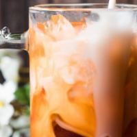 Thai Iced Tea · Thai tea, milk, and sugar mix together until flavorful and delicious.