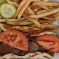 Plain Gyros Sandwich · Gyro meat sliced thin served with lettuce, tomatoes, onion and gyro sauce on toasted pita br...