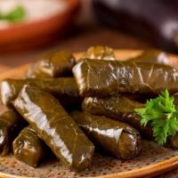 #6. Grape Leaves · Green onions, tomatoes and mint cooked in olive oil and served with yogurt.