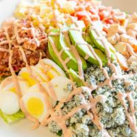 Cobb Salad · Mixed greens, poached chicken, blue cheese, avocado, egg, bacon, tomatoes, Swiss cheese, and...
