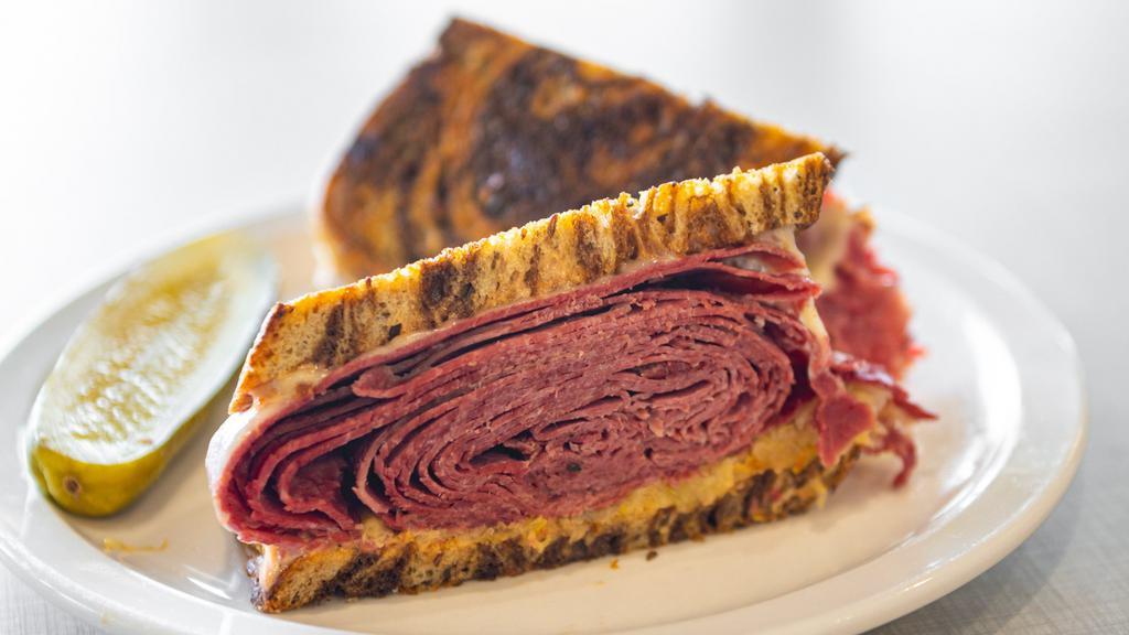 Classic Reuben · Corned beef, Swiss cheese, sauerkraut, and Russian dressing on grilled seeded marble rye.