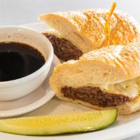 Deli Dip · Slow roasted brisket and melted Swiss cheese on a sesame sub roll with au jus for dipping.