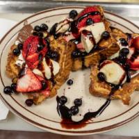 French Toast Explosion · Strawberries, bananas, blueberries, Nutella and cream cheese frosting. Topped with a drizzle...