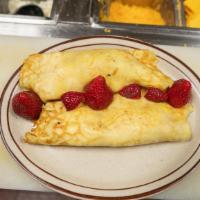 Strawberry And Bananas Crepe · Stuffed with cream cheese frosting, strawberries and bananas topped with caramel and chocola...