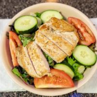 Chicken Finger Salad · Crispy chicken fingers on a bed of crisp lettuce, tomato, cucumber and cheddar cheese, serve...
