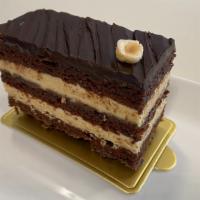 Dacquoise | New · Alternating layers of hazelnut and chocolate cake, hazelnut cream and chocolate feuillantine...