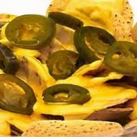 Nachos · Nacho chips with yellow cheese and jalapeños.