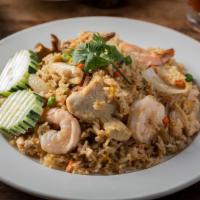 Combo Fried Rice · Stir fried rice with chicken, beef, and shrimp, egg, onions, green pea, and carrot in a trad...