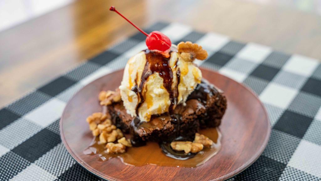 Brownie Sundae · Warm chocolate fudge brownie topped with vanilla ice cream drizzled with chocolate and caramel syrup topped with walnuts.