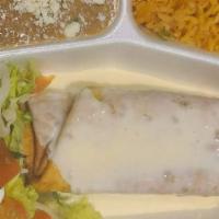 Chimichangas · Your choice of soft or fried tortillas filled with beef tips or chicken and topped with our ...