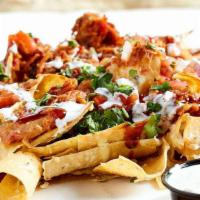 Bbq Pork Nachos · Slow-roasted pork over freshly fried tortilla chips, layered with a five cheese blend and to...