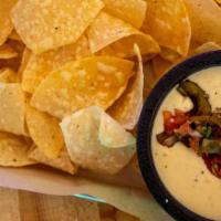 Queso Fundido · Homemade queso, roasted green peppers, tomatoes, and red onions. Served with house fried tor...