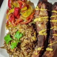 Sub-Saharan Pork Ribs · Smoked pork ribs, Jollof rice, veggies