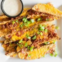 Loaded Potato Wedges · House cut potato wedges topped with cheddar cheese, chopped bacon and green onions. Served w...