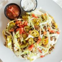 Loaded Nachos · Our house fried corn tortilla chips smothered with homemade queso Blanco sauce and topped wi...