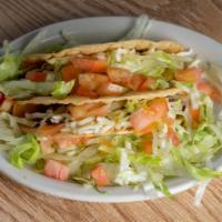 Hard Shell Taco · With ground beef, lettuce, tomatoes, and cheese.