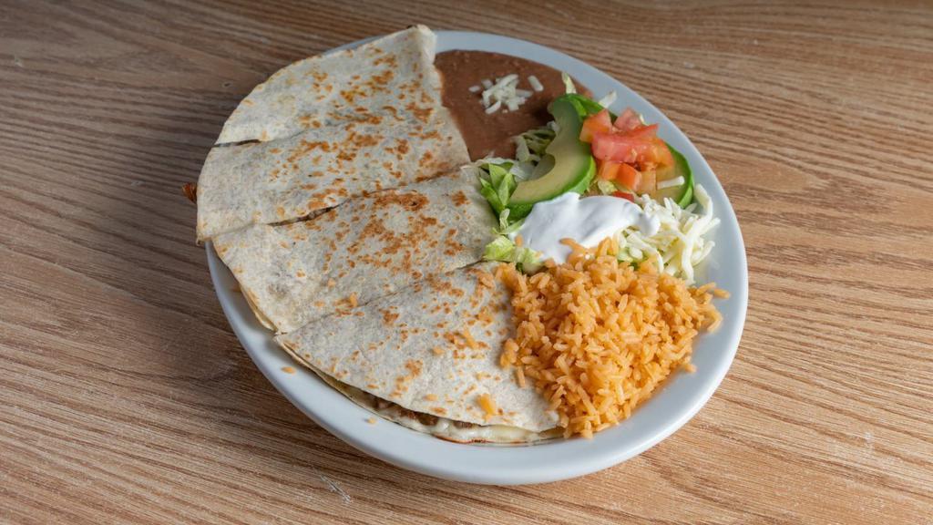 Quesadilla · One quesadilla with your choice of steak, chicken or pork. Served with rice, beans, lettuce, tomatoes, slice of avocado and sour cream.