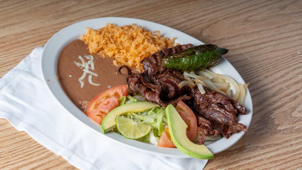 Carne Asada · Grilled skirt steak topped with sautéed onions.

Your choice of flour or corn tortillas.