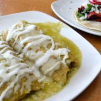 Tamales · Two chicken or pork tamales in green or red sauce, topped with mozzarella cheese and sour cr...
