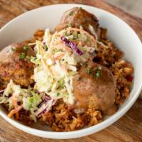 Meatball Fricassee · Pork meatballs,  gravy, house slaw, and dirty rice.