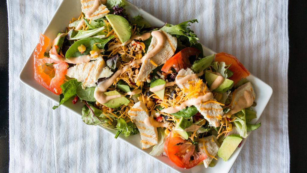 Southwest Chicken Salad · Grilled chicken breast, corn roasted salsa, tomato, cheddar cheese, avocado and chipotle ranch dressing.
