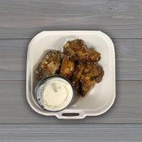 Chicken Wings · Five oven baked chicken wings tossed in your choice of sauce and served with a side of ranch.