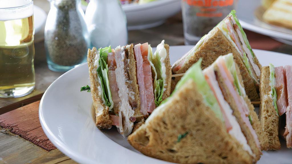 Hen Club · Piled high with turkey, bacon, ham, cheddar, lettuce, tomato and mayo on wheat.