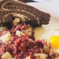 Corn Beef Hash · Corn beef, onions, carrots, red peppers with hash brown potatoes served with two eggs and ma...