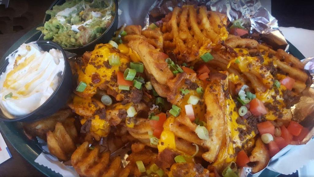 Nacho Fries (Half Order) · waffle fries (or chips) topped with melted cheese, tomatoes, bacon, green onion, ground beef, guacamole, and sour cream
Add pulled pork $5 chicken $5
Add grilled steak $6