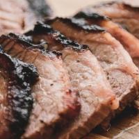 Pound Beef Brisket · Naturally raised beef brisket, dry rubbed and smoked heavy, sliced to order.